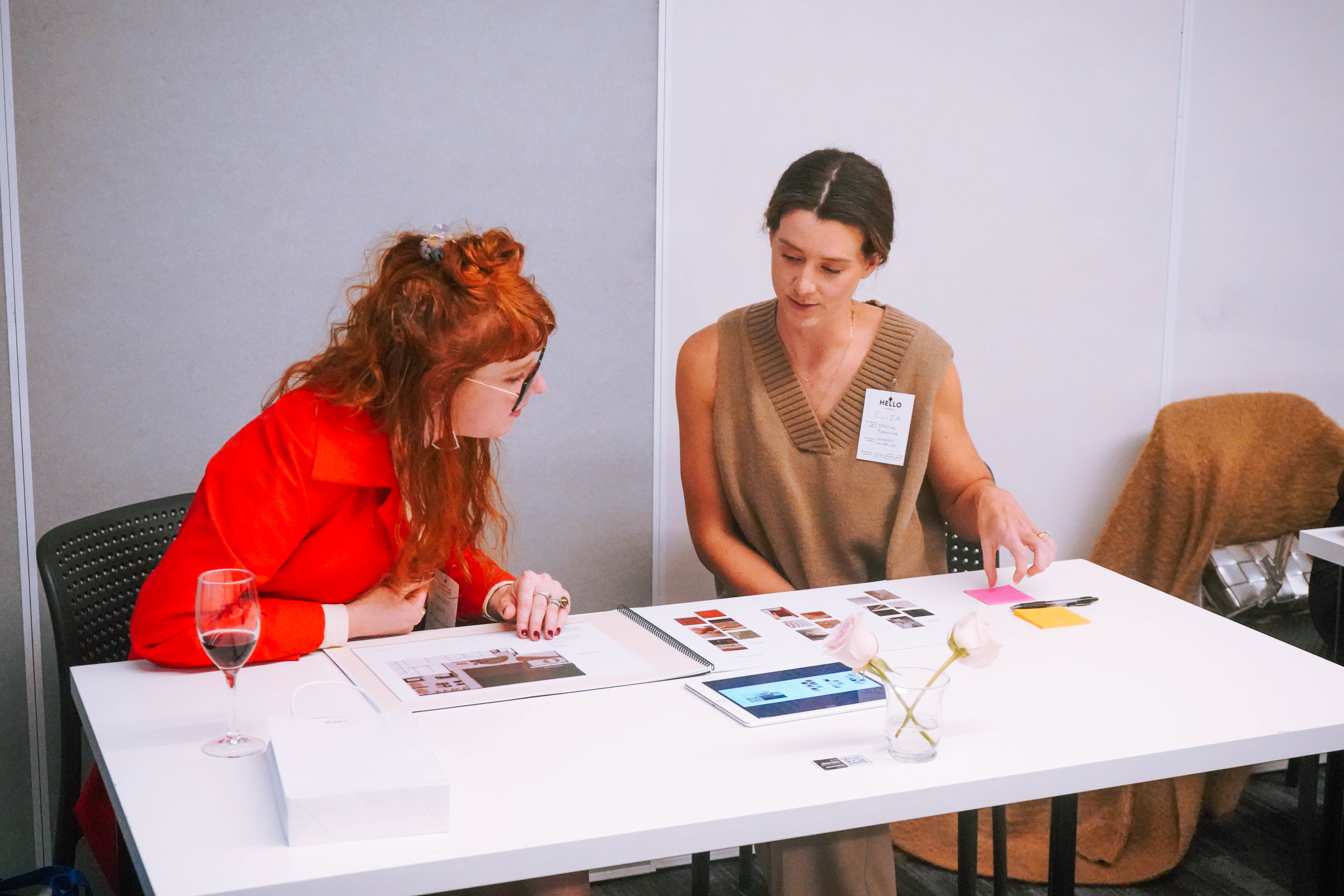 Collarts teacher and student sitting at a table looking at interior design portfolio
