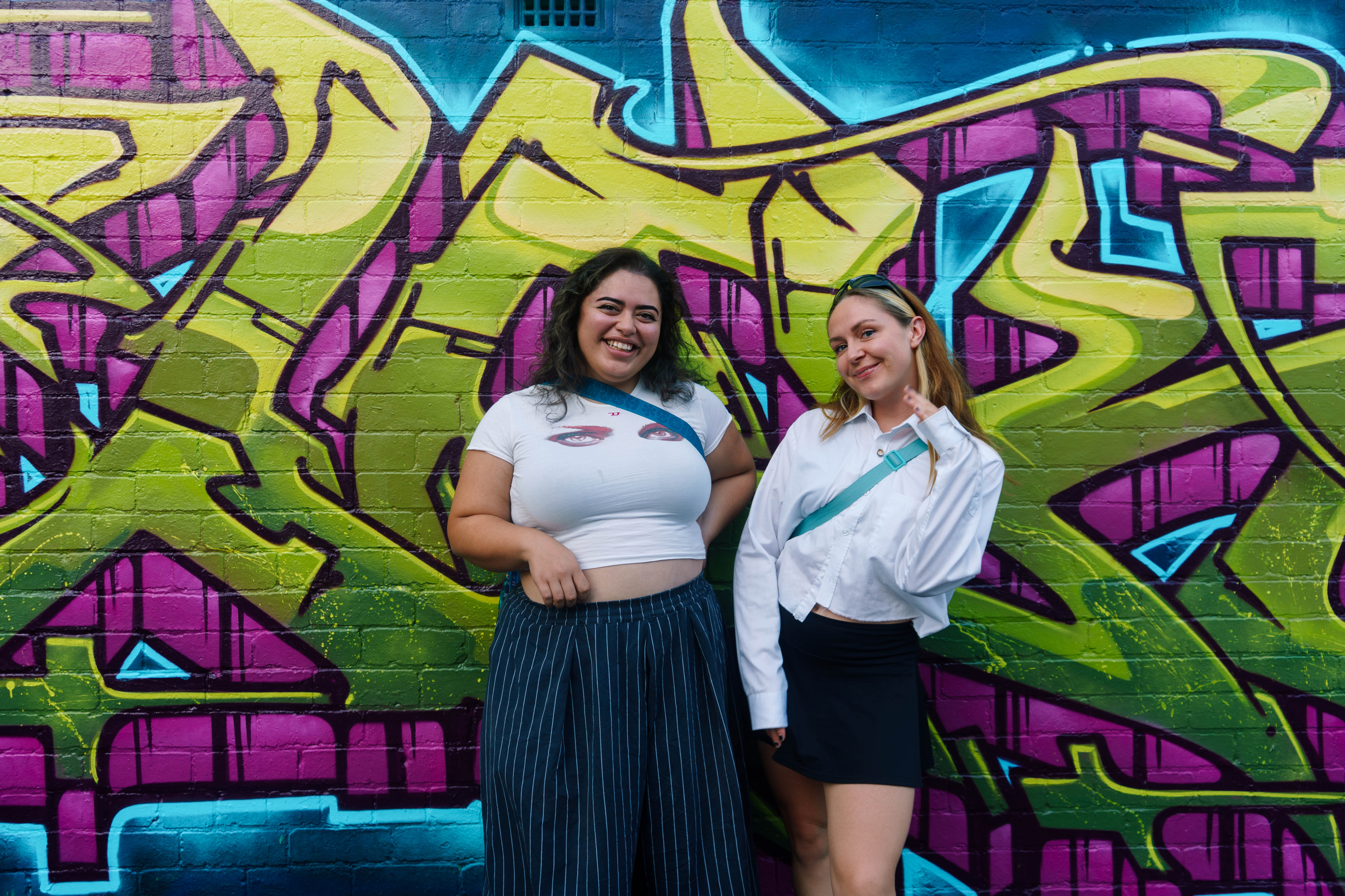 Image below: Two music production students standing in front of a graffiti wall in Collingwood. 