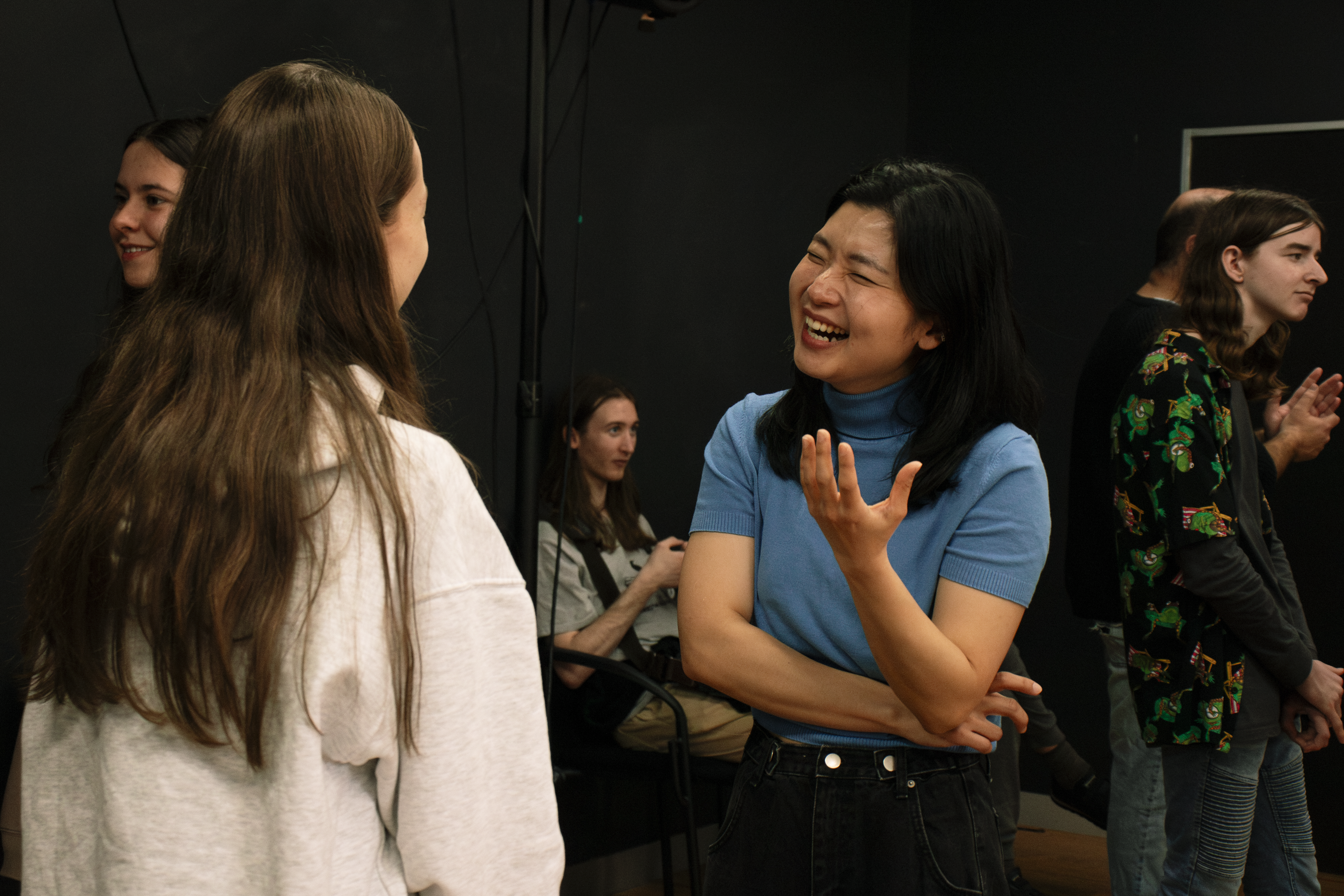 Collarts students laughing and smiling with another student 