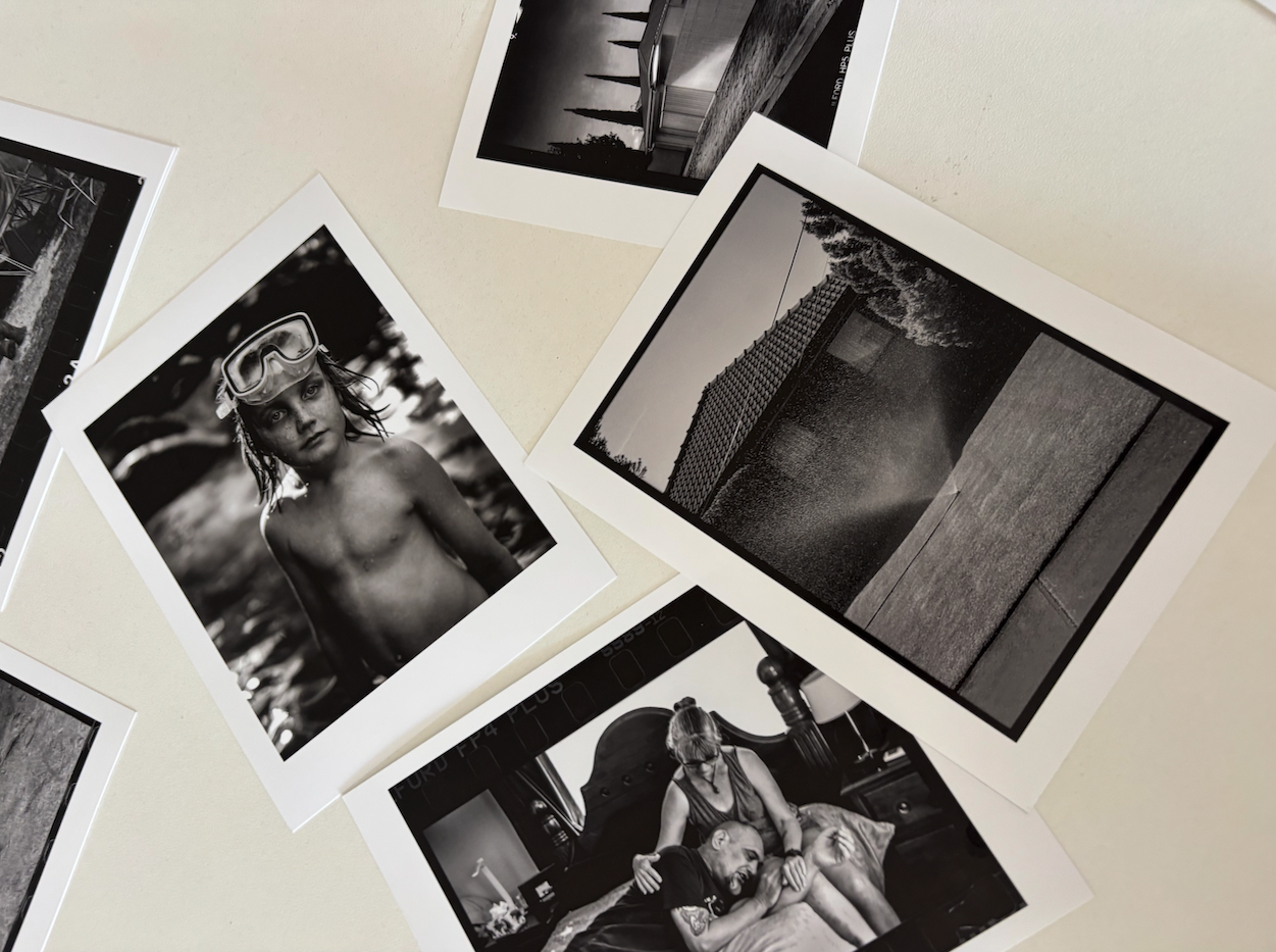 Close up of Collarts students' printed photos scattered on table 