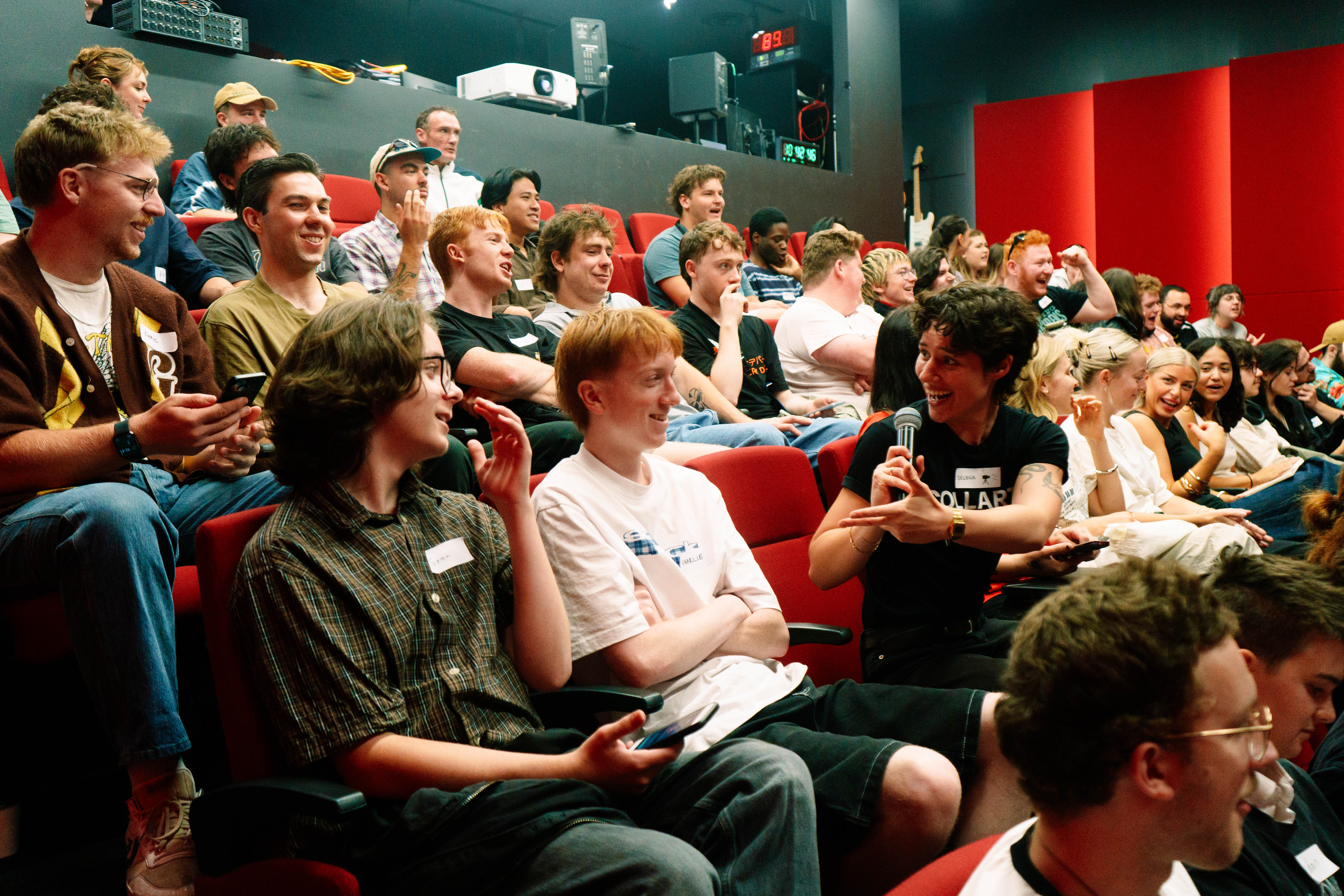 Auditorium full of Collarts students smiling and chatting to each other