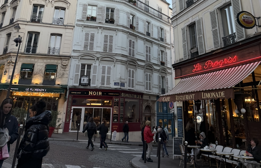 Parisian street scene with cafes and small shop fronts 
