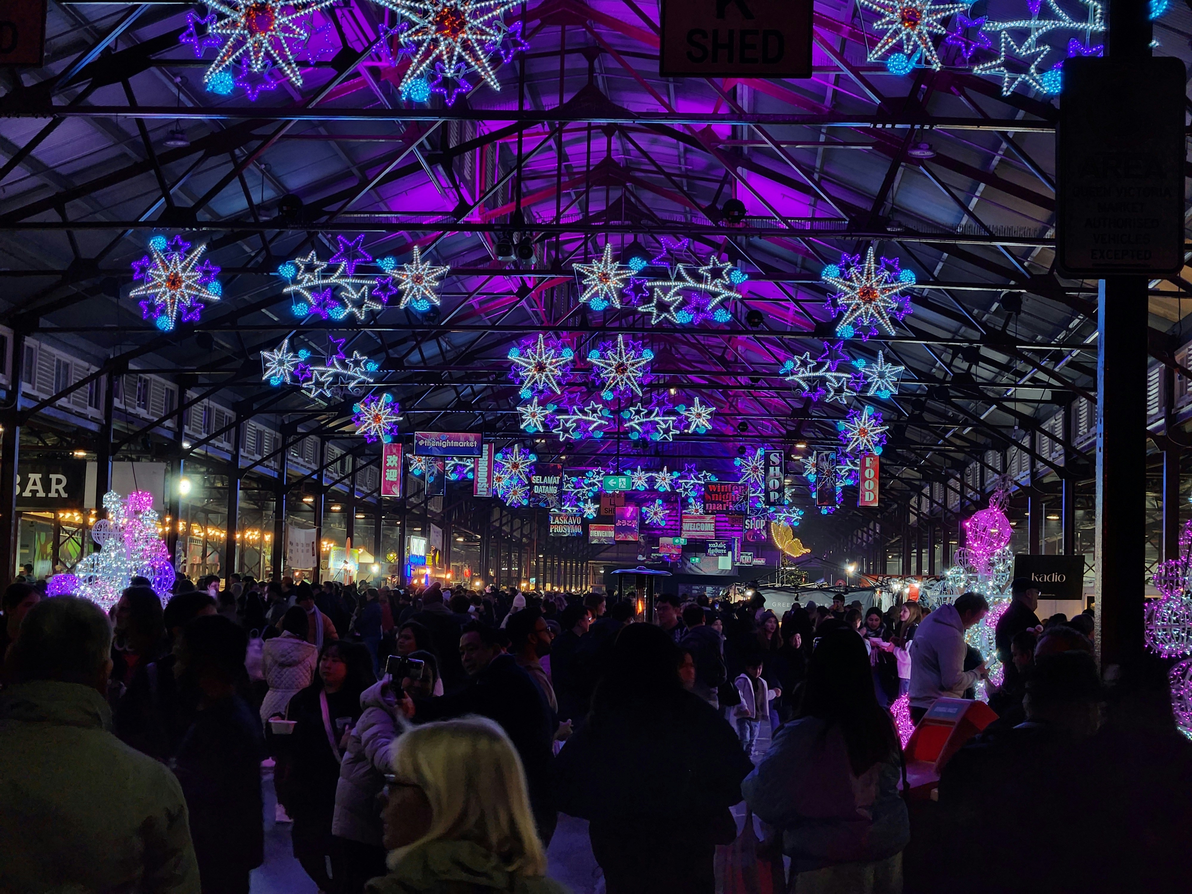 Winter night market scene with hanging snowflake lights at Queen Victoria market in Melbourne