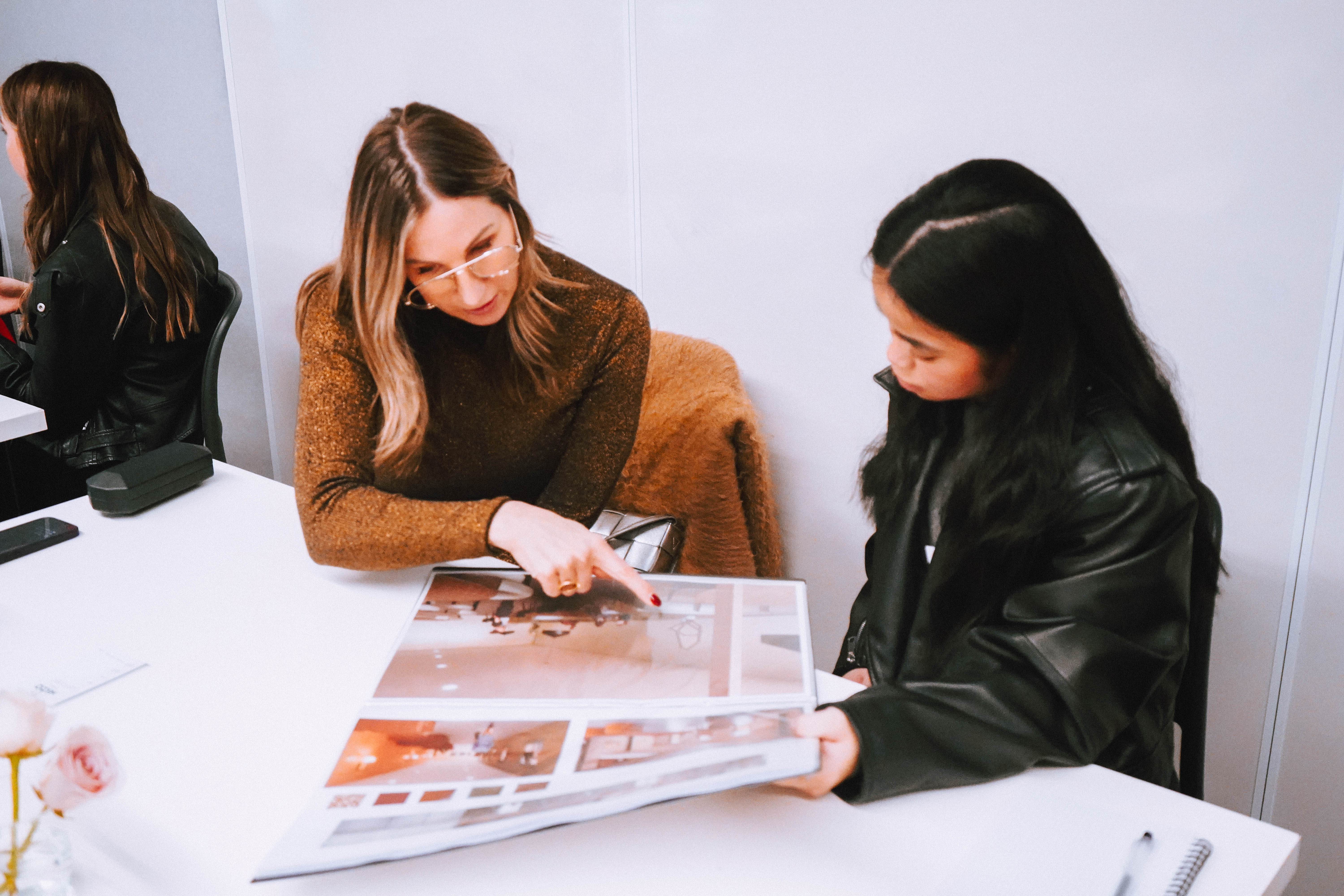 Collarts interior design teaching flicking through student's portfolio with her
